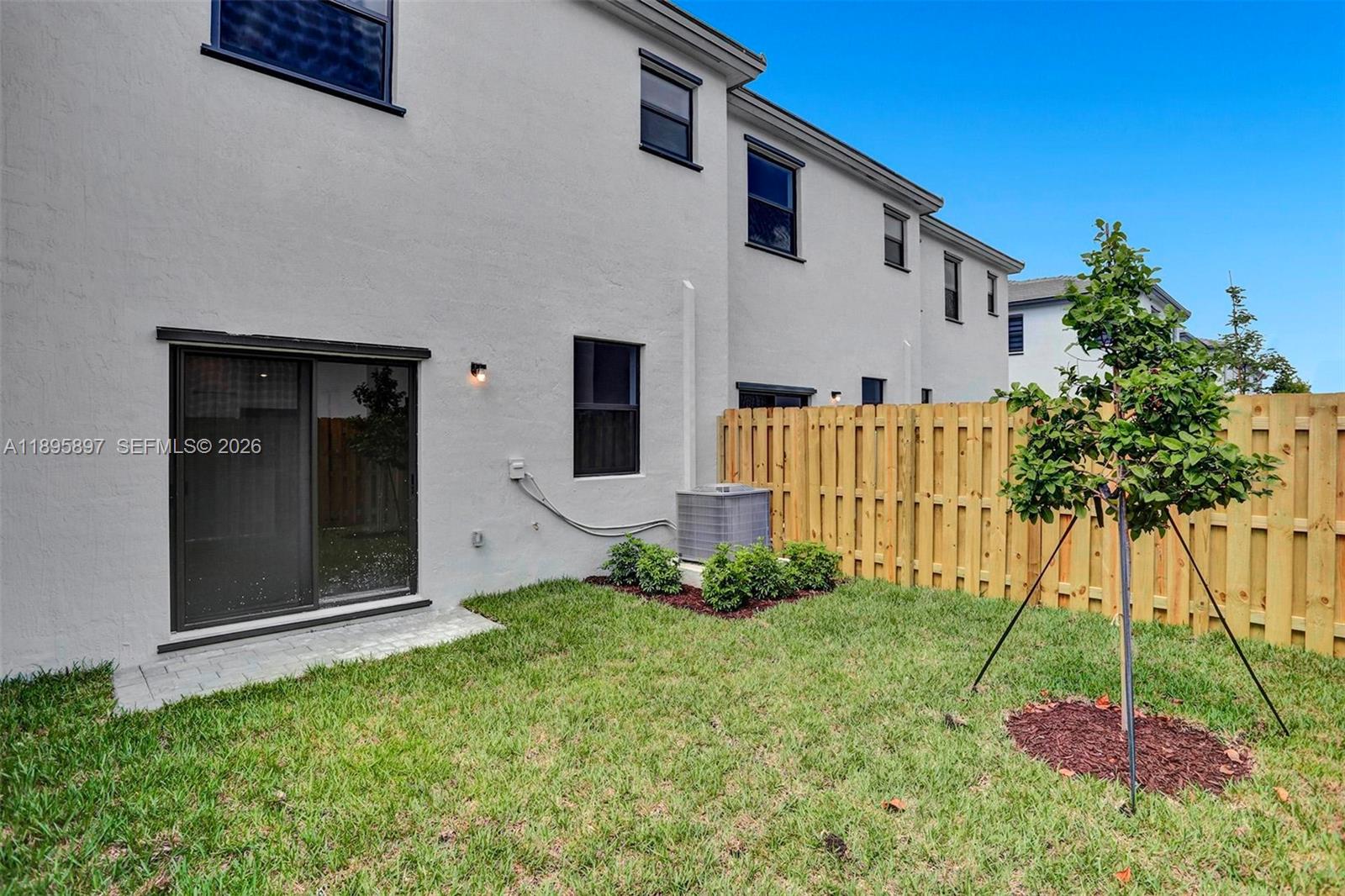 13375 Southwest 287th Street Homestead, FL 33033 - Photo 20 of 44 a backyard of a house with plants and outdoor seating
