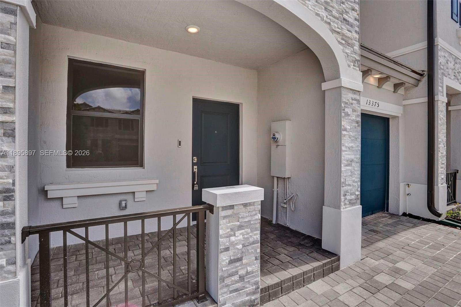 13375 Southwest 287th Street Homestead, FL 33033 - Photo 2 of 44 a view of a hallway with a dining room and front door