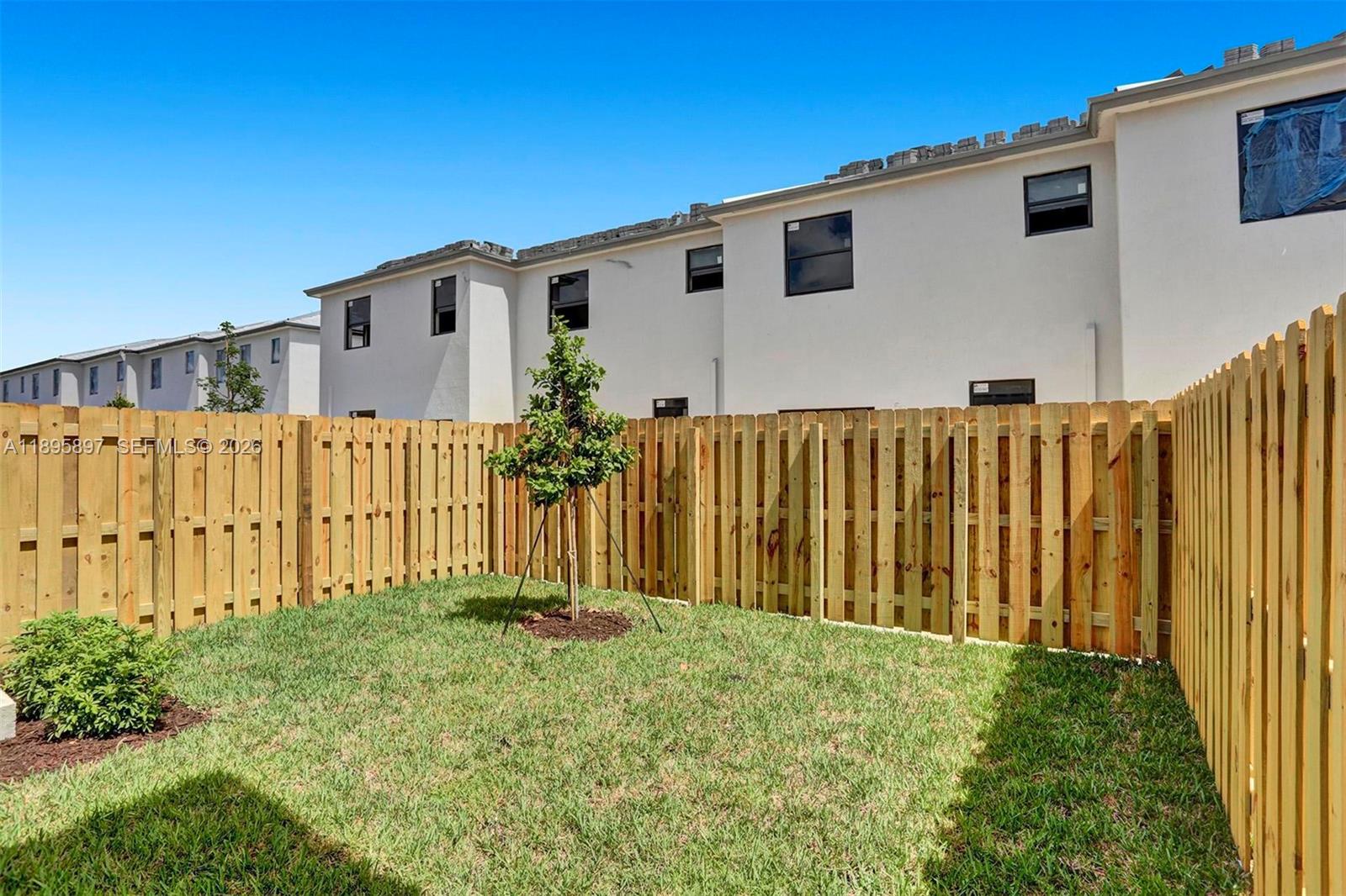 13375 Southwest 287th Street Homestead, FL 33033 - Photo 23 of 44 a front view of a house with a garden