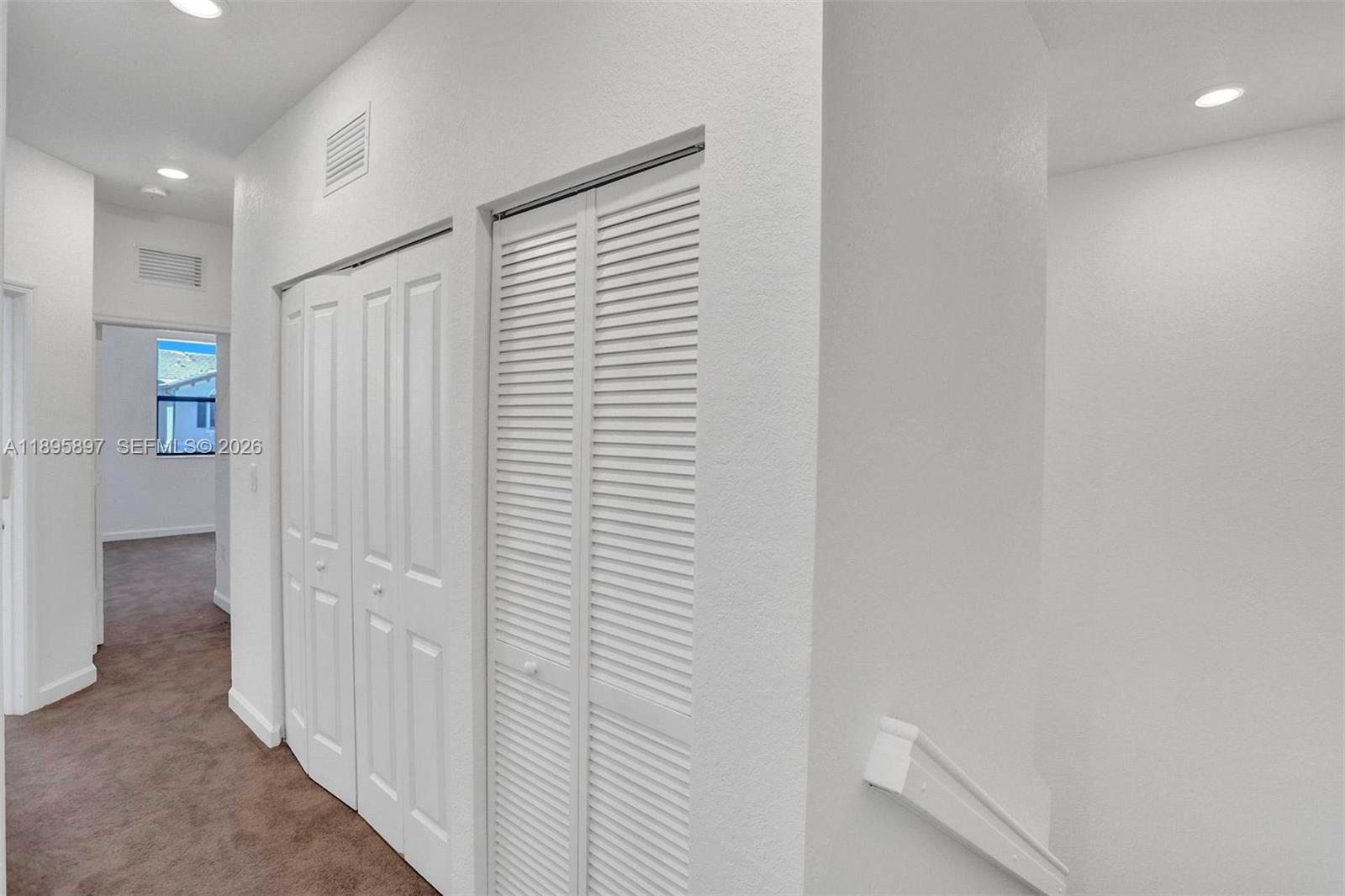 13375 Southwest 287th Street Homestead, FL 33033 - Photo 30 of 44 a view of a hallway with closet and bathroom