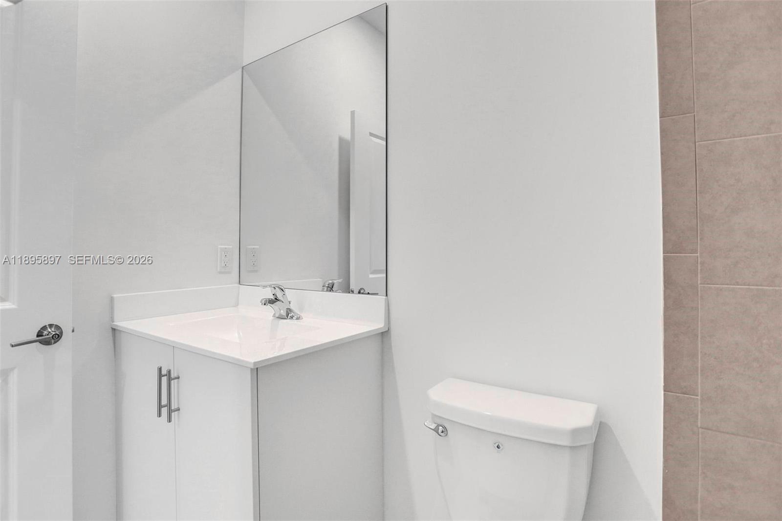 13375 Southwest 287th Street Homestead, FL 33033 - Photo 32 of 44 a bathroom with a sink a toilet and a mirror