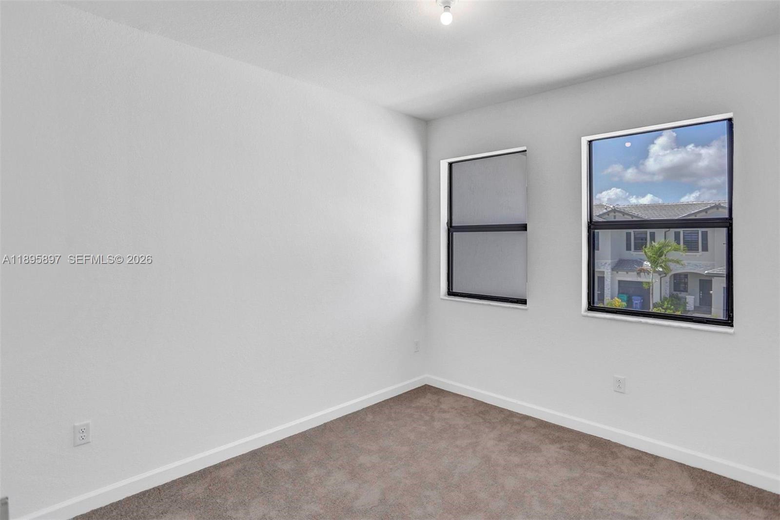13375 Southwest 287th Street Homestead, FL 33033 - Photo 38 of 44 an empty room with windows and closet