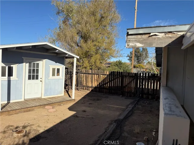 a front view of a house with wooden fence