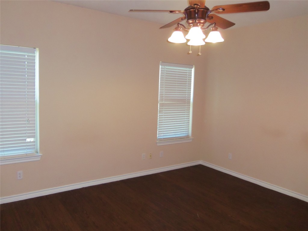 10611 Lake Beach Drive Dripping Springs, TX 78620 - Photo 11 of 22 a view of wooden floor and a chandelier fan in a room