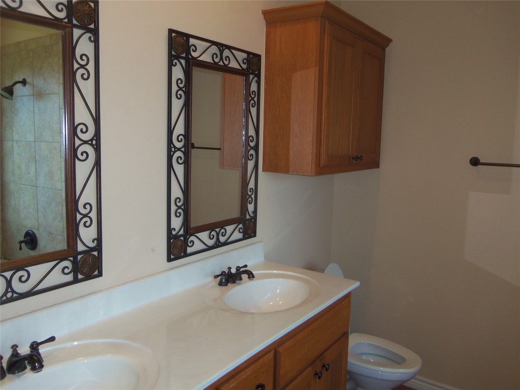 10611 Lake Beach Drive Dripping Springs, TX 78620 - Photo 12 of 22 a bathroom with a sink and a mirror
