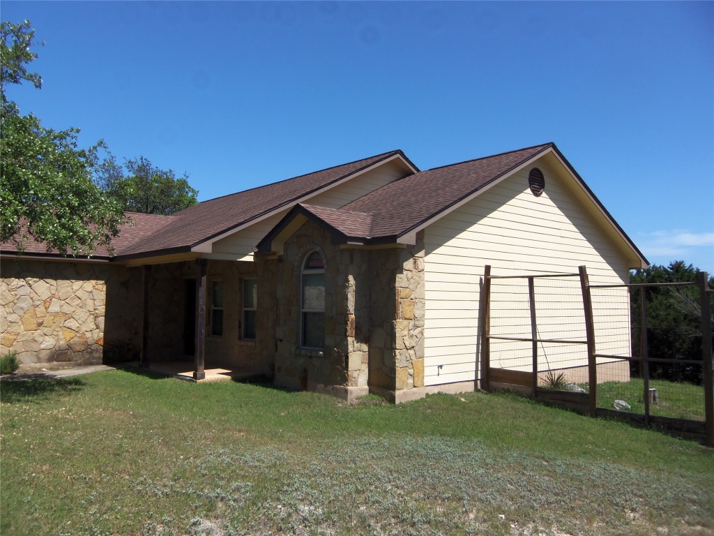 10611 Lake Beach Drive Dripping Springs, TX 78620 - Photo 20 of 22 a backyard of a house with lots of green space