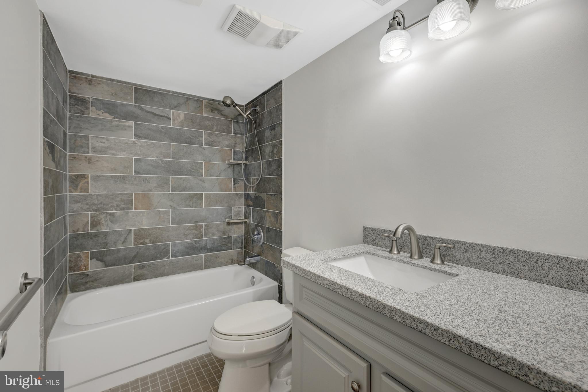 1941 Upper Lake Drive Reston, VA 20191 - Photo 30 of 51 a bathroom with a granite countertop bathtub sink vanity mirror and toilet