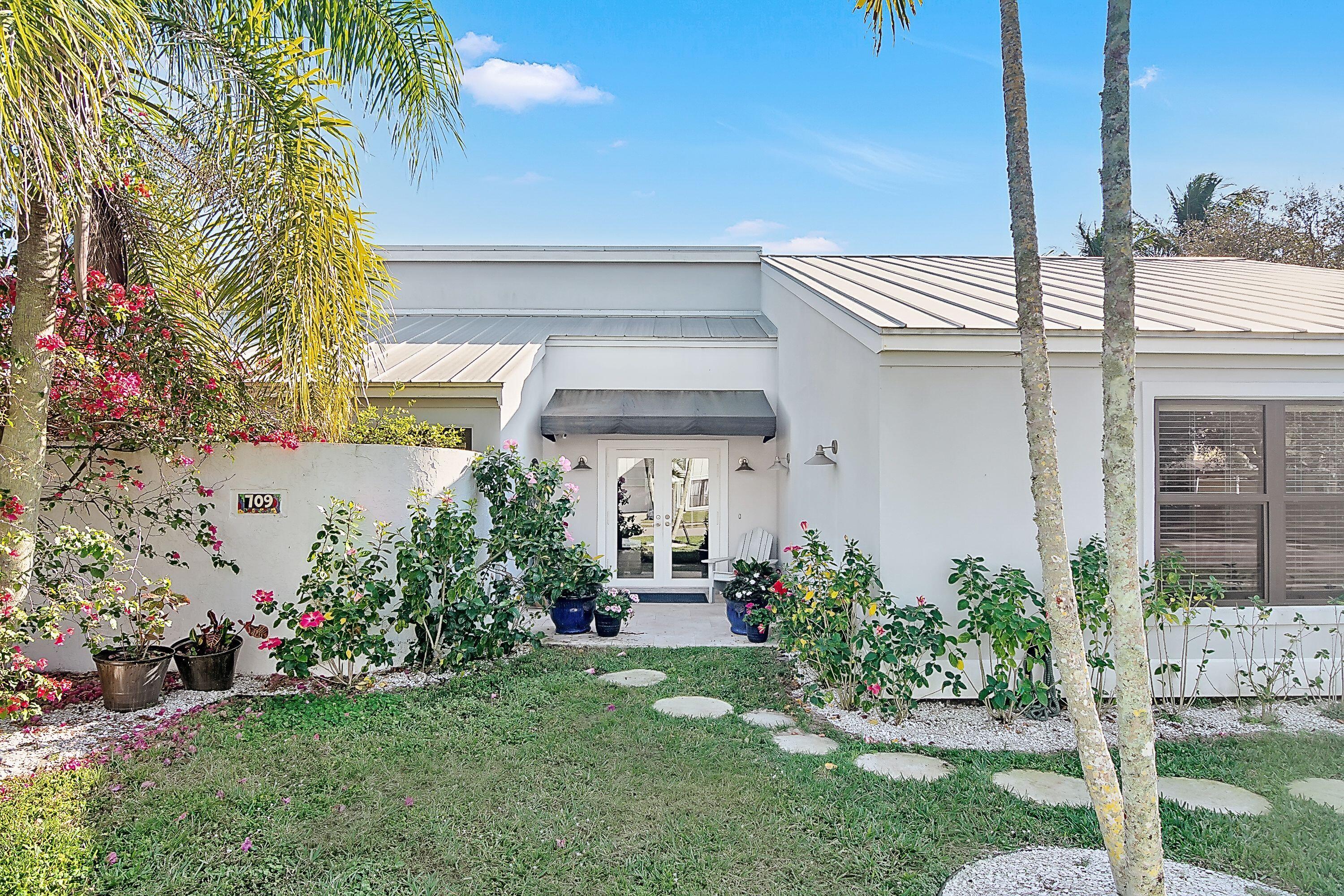 709 Irwin Lane Jupiter, FL 33458 - Photo 1 of 37 a front view of a house with a garden