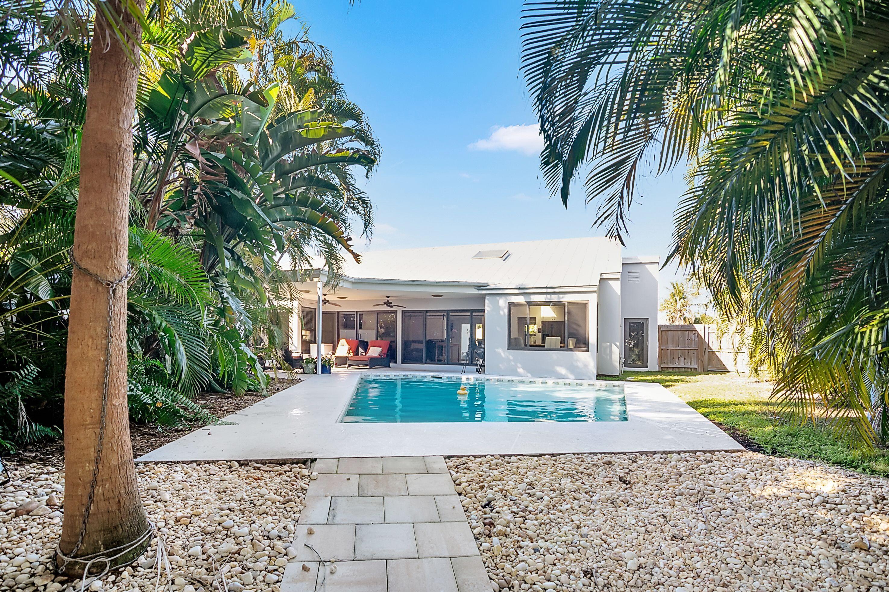 709 Irwin Lane Jupiter, FL 33458 - Photo 11 of 37 a front view of a house with garden