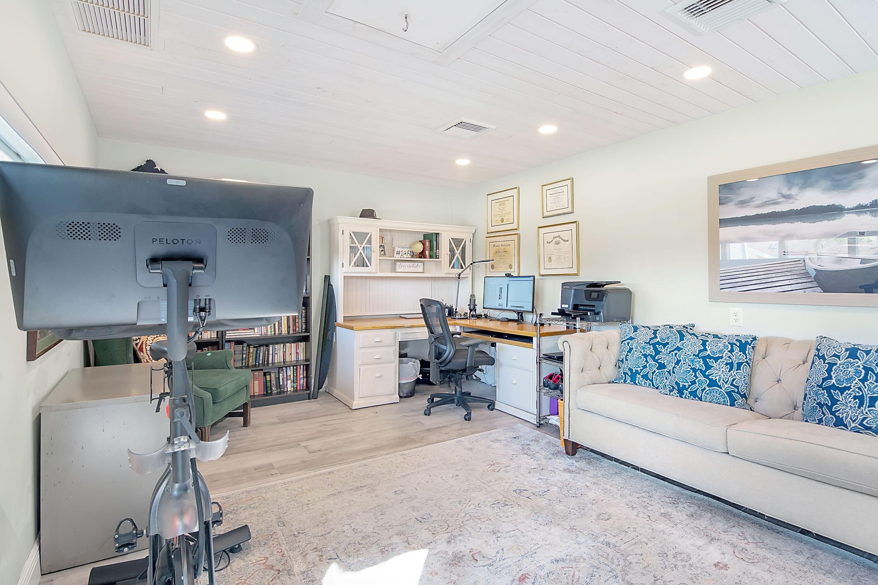 709 Irwin Lane Jupiter, FL 33458 - Photo 14 of 37 a living room with furniture and a work place