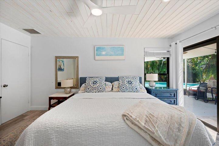 709 Irwin Lane Jupiter, FL 33458 - Photo 22 of 37 a bedroom with a large bed and a large window