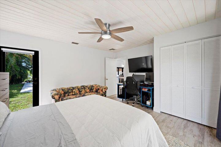 709 Irwin Lane Jupiter, FL 33458 - Photo 25 of 37 a bedroom with a bed and a tv
