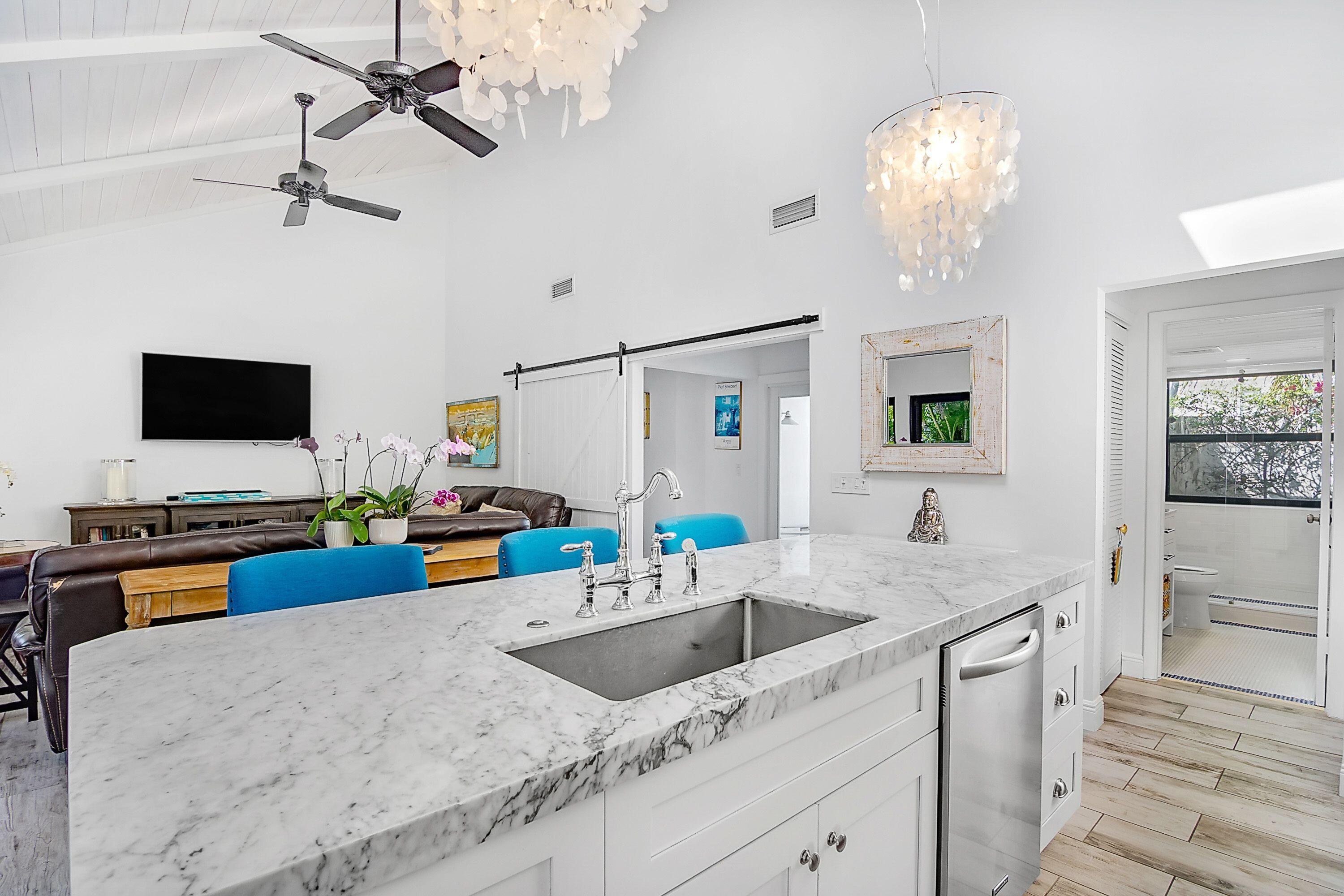 709 Irwin Lane Jupiter, FL 33458 - Photo 6 of 37 a kitchen with stainless steel appliances granite countertop a sink dishwasher and a stove with wooden floor