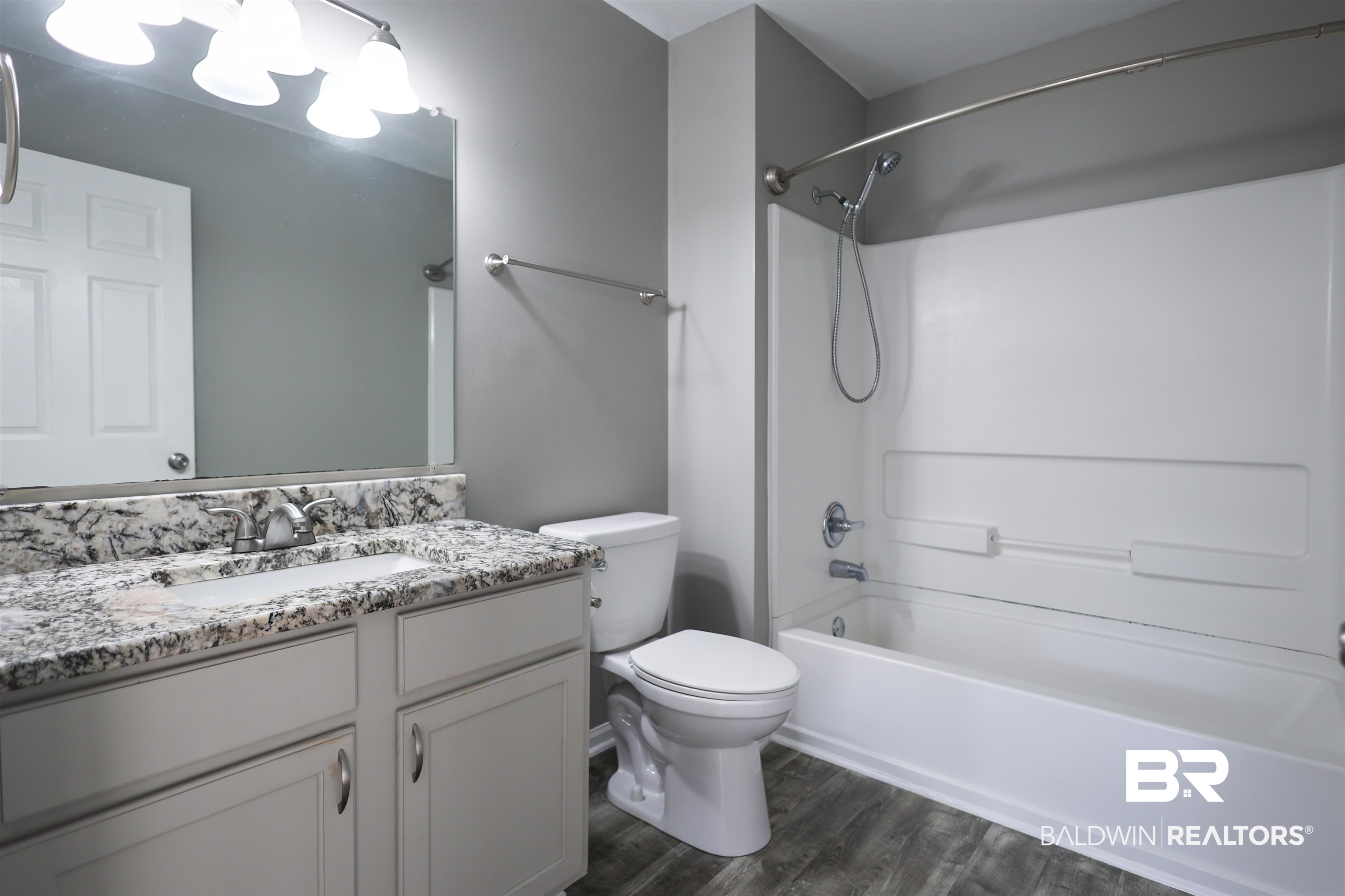 1517 Regency Road, Unit 125 Gulf Shores, AL 36542 - Photo 21 of 26 Full bath with bathtub / shower combination, vanity, and dark wood-type flooring