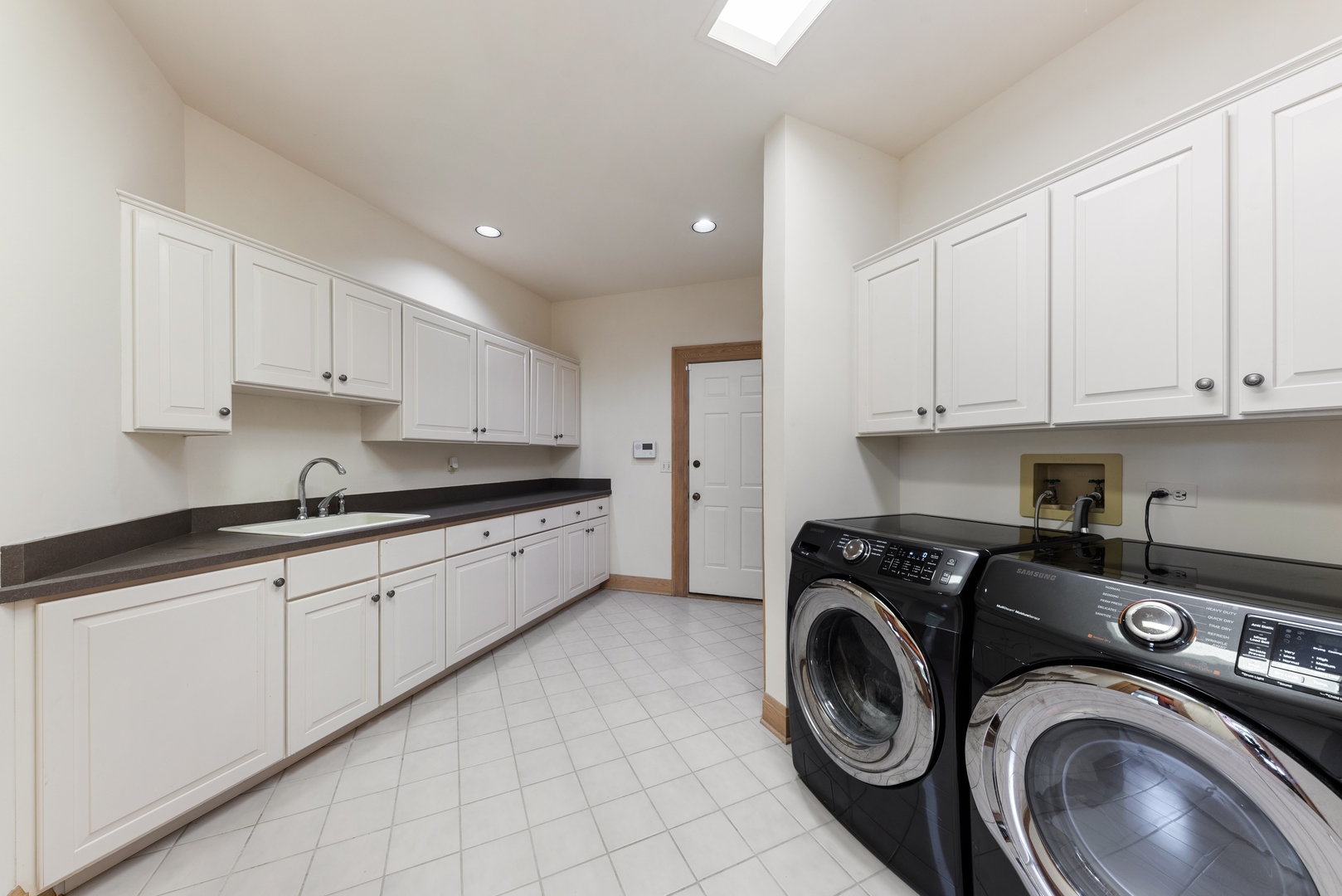 9 South Wynstone Drive North Barrington, IL 60010 - Photo 26 of 31 a large white kitchen with stainless steel appliances granite countertop a sink a stove and cabinets