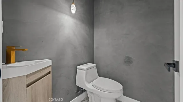 a white toilet sitting next to a white sink