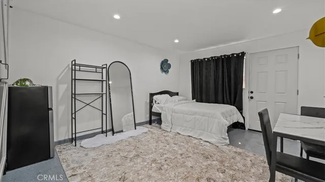 a bedroom with a bed and a dresser