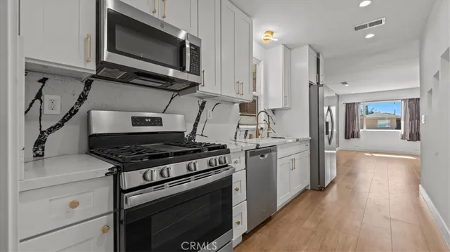 a kitchen with a stove and a microwave