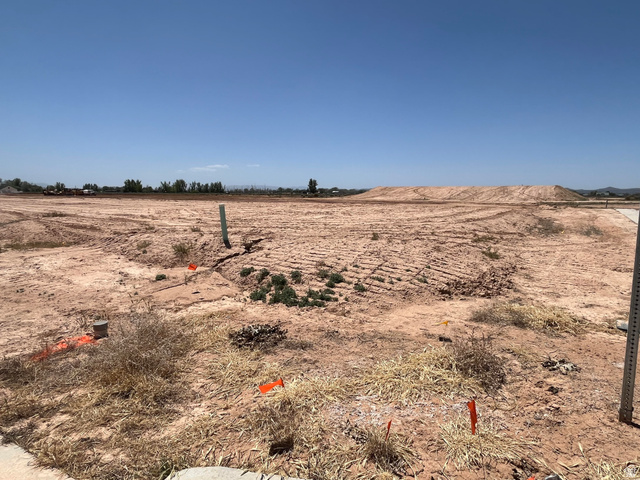 5183 North 75 East, Unit 213 Enoch, UT 84721 - Photo 1 of 12 Expansive, undeveloped parcel featuring cleared land, visible utility stub, and a distant treeline