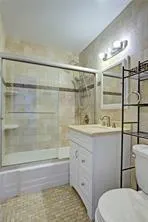 a bathroom with a sink a toilet and shower