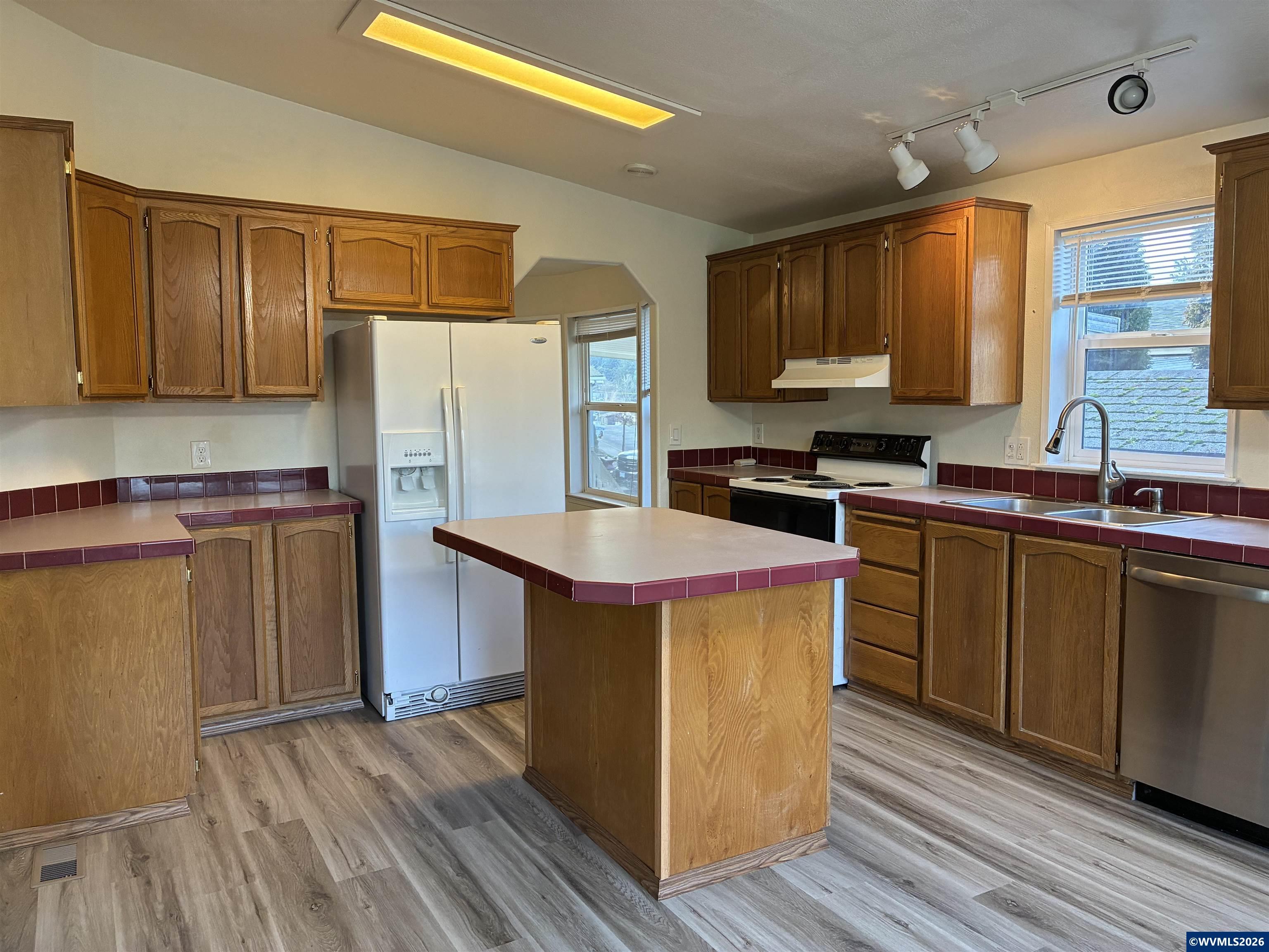 2000 Robins Lane Southeast, Unit 7 Salem, OR 97306 - Photo 7 of 39 a kitchen with stainless steel appliances a sink cabinets and wooden floor