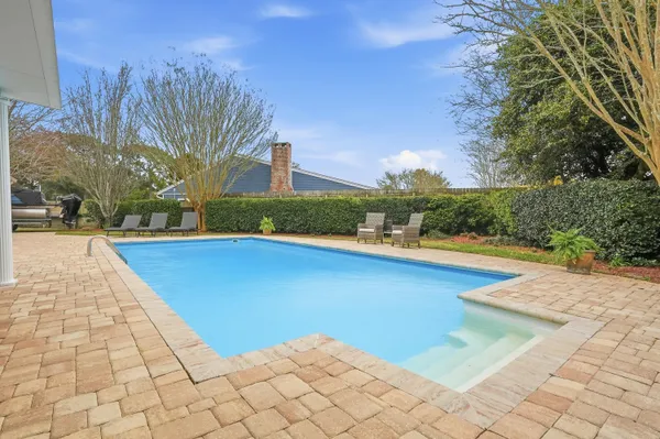 a view of swimming pool with lounge chair