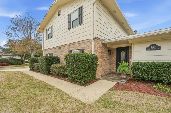 a dining room with furniture a chandelier and wooden floor