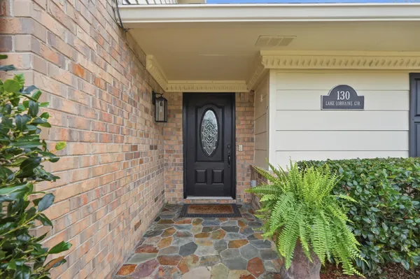 a dining room with furniture a chandelier and wooden floor