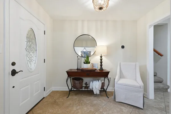 a living room with furniture a fireplace and a large window