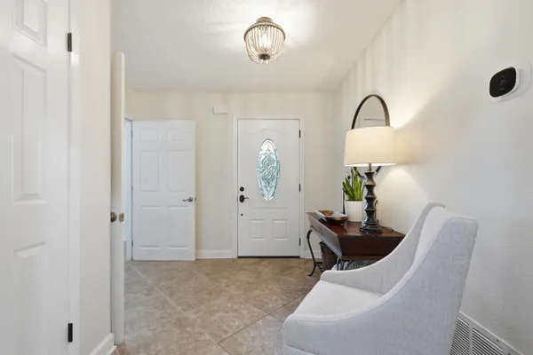 a living room with a fireplace and potted plant
