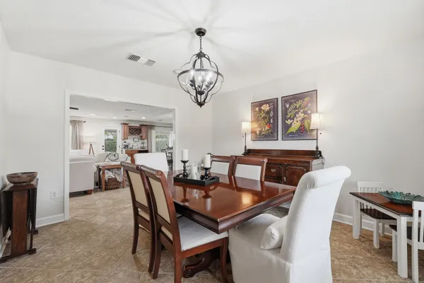 a living room with furniture kitchen view and a potted plant