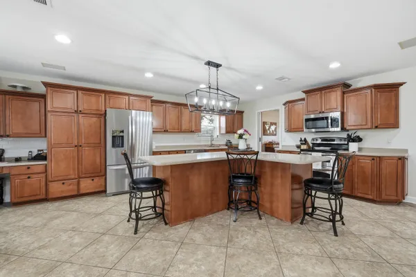 a kitchen that has a lot of cabinets in it and appliances