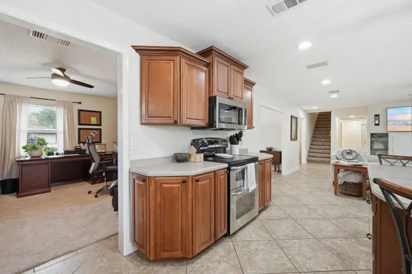 a living room with furniture a window and a flat screen tv