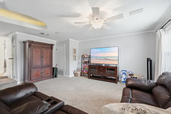 a bedroom with a bed dresser and a window