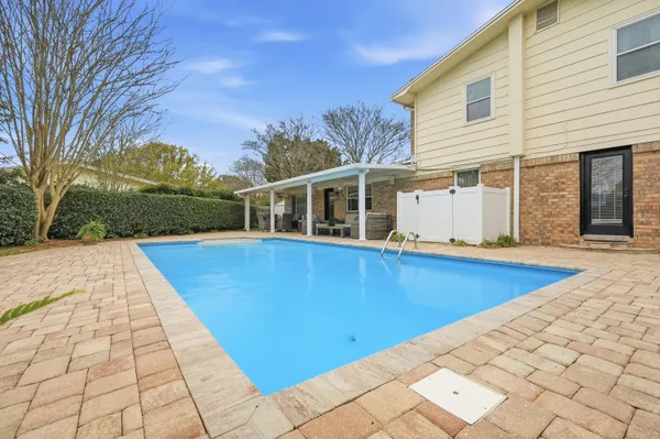 a view of a house with backyard and sitting area