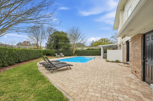 a view of a patio with a table and chairs