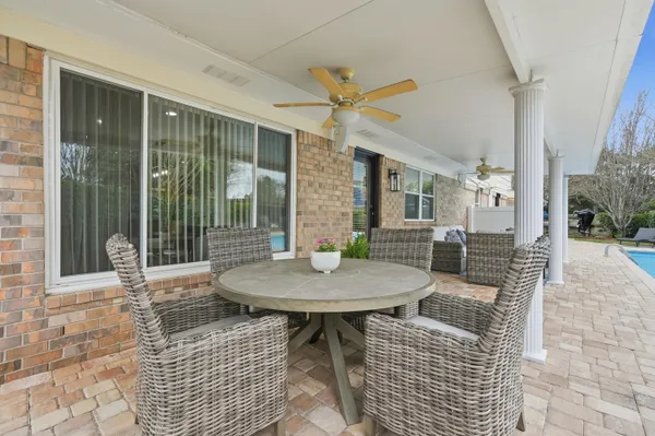 a view of a white house next to a yard