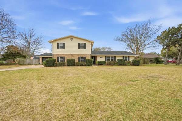 a living room with furniture a table and a chandelier