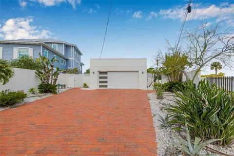 a house with a yard and a large tree