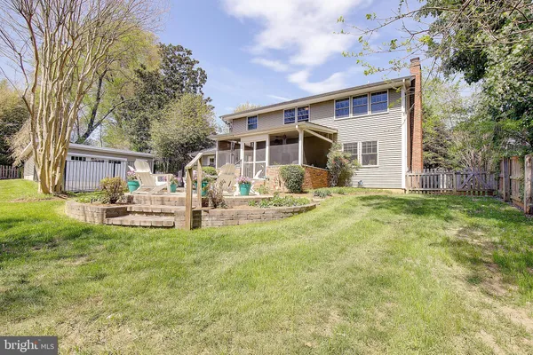 a dining room with chandelier and wooden floor