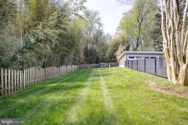 a dining room with chandelier and wooden floor