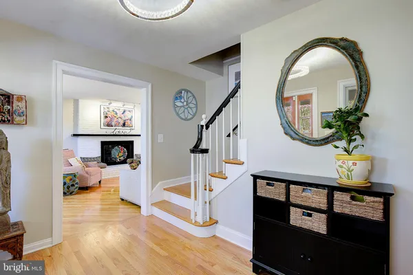 a kitchen with stainless steel appliances granite countertop a refrigerator oven stove a dining table and chairs with wooden floor