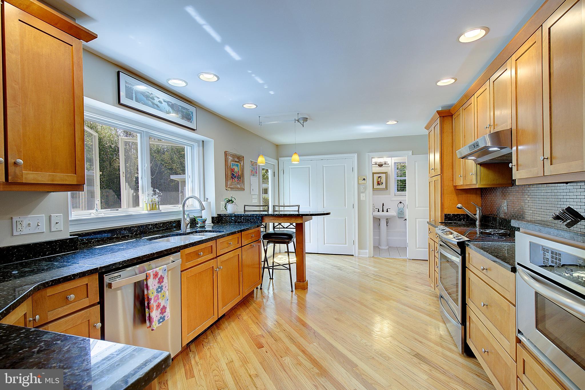 2 Isaacs Street Annapolis, MD 21401 - Photo 33 of 63 a large kitchen with stainless steel appliances granite countertop a stove and a sink