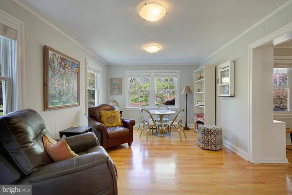 a bathroom with a tub a sink and a large window