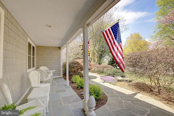 a view of swimming pool with a yard and trees in the background