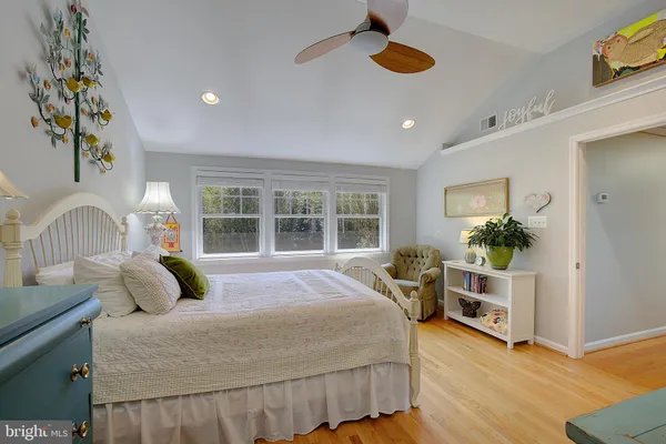 a living room with furniture and a ceiling fan