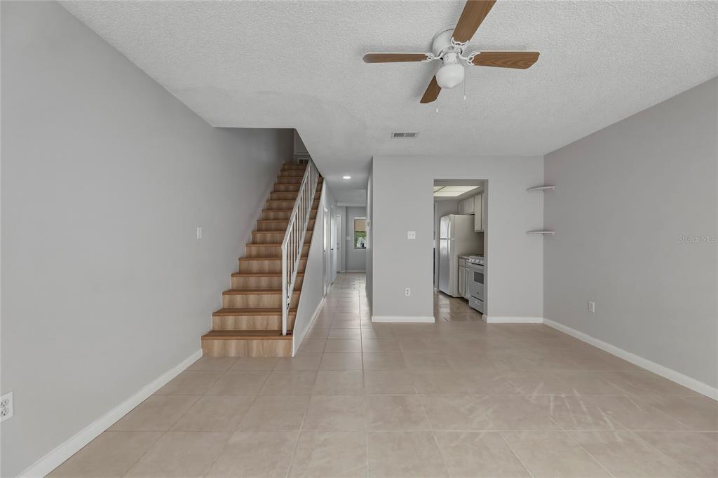 4799 Sisson Road Titusville, FL 32780 - Photo 13 of 23 wooden floor in an empty room with a ceiling fan