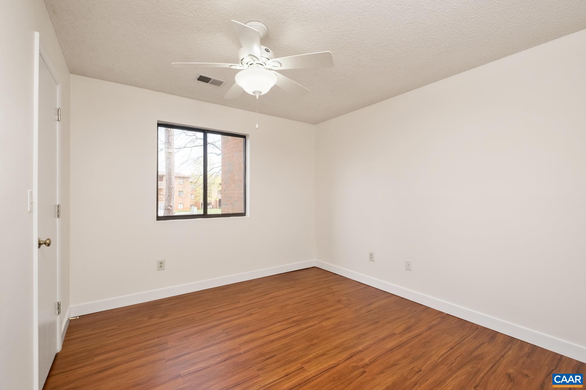103 Turtle Creek Road, Unit 2 Charlottesville, VA 22901 - Photo 15 of 24 wooden floor in an empty room with a window