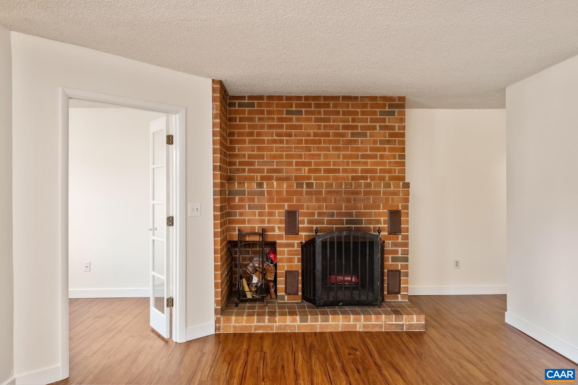 103 Turtle Creek Road, Unit 2 Charlottesville, VA 22901 - Photo 4 of 24 a view of livingroom with hardwood floor and a fireplace