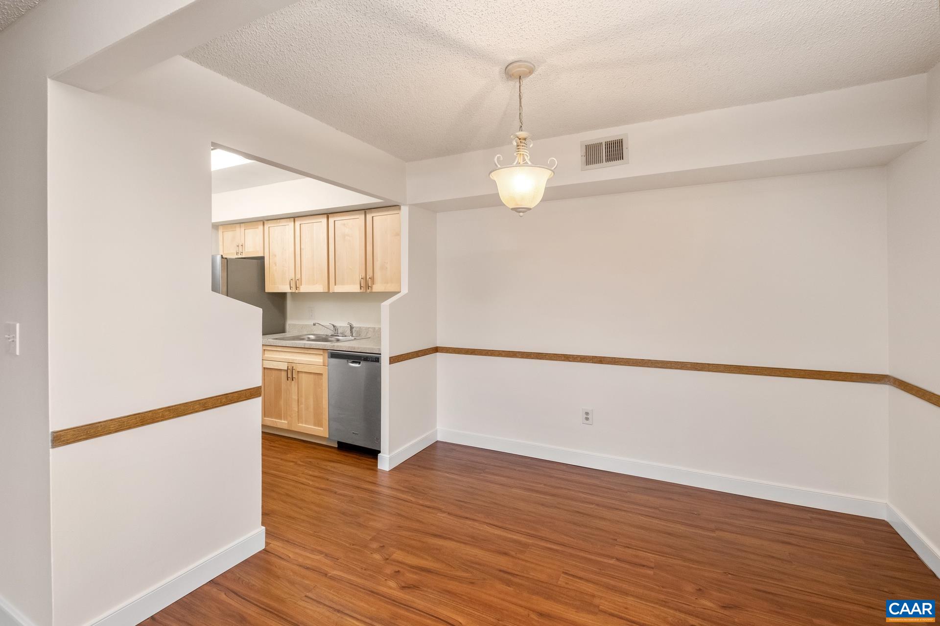 103 Turtle Creek Road, Unit 2 Charlottesville, VA 22901 - Photo 7 of 24 a kitchen with a refrigerator and a stove top oven